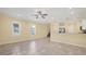 Spacious living room and kitchen area, featuring tile floors, neutral walls, and plenty of natural light at 1033 Grantham Dr, Sarasota, FL 34234