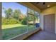 A screened in lanai featuring a ceiling fan and view of the backyard at 1033 Grantham Dr, Sarasota, FL 34234