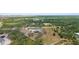 Expansive aerial view of the property showcasing its natural surroundings and the modern home design at 1116 406Th E Ct, Myakka City, FL 34251