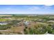 Expansive aerial view of a modern home nestled within a lush, green landscape at 1116 406Th E Ct, Myakka City, FL 34251