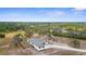 Aerial shot of a modern home with surrounding landscape and neighboring houses in a peaceful area at 1116 406Th E Ct, Myakka City, FL 34251