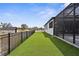View of the artificial turf backyard that connects to the screened in patio at 1116 406Th E Ct, Myakka City, FL 34251
