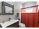 Bathroom featuring wood-look vanity, decorative mirror, and shower with curtain at 1116 406Th E Ct, Myakka City, FL 34251