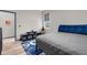 Bedroom featuring blue and gray color scheme, wood-look flooring, and a modern bedframe at 1116 406Th E Ct, Myakka City, FL 34251