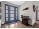 Elegant entryway with a decorative console table and blue frosted front door at 1116 406Th E Ct, Myakka City, FL 34251