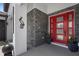 Stylish front entry features a bright red modern door with stone accents at 1116 406Th E Ct, Myakka City, FL 34251