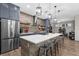 Kitchen featuring a spacious island with bar seating, stainless steel refrigerator, and open shelving at 1116 406Th E Ct, Myakka City, FL 34251