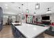Modern kitchen with sleek countertops, an island sink, and open access to the living area at 1116 406Th E Ct, Myakka City, FL 34251