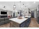 Open kitchen with a large island, modern appliances, and stylish pendant lighting at 1116 406Th E Ct, Myakka City, FL 34251