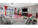 Cozy living room featuring a contemporary fireplace and large windows with natural light at 1116 406Th E Ct, Myakka City, FL 34251