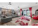 Bright living room with open kitchen, large gray sectional, and access to outdoor patio at 1116 406Th E Ct, Myakka City, FL 34251
