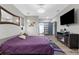 Calm bedroom showcasing modern decor, an entertainment center, and closet access at 1116 406Th E Ct, Myakka City, FL 34251