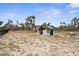 View of the exterior of a cinder block outbuilding with a dark roof on a sunny day at 1116 406Th E Ct, Myakka City, FL 34251