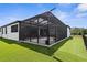 Screened in patio featuring a dark frame and new artificial turf along the perimeter of the house at 1116 406Th E Ct, Myakka City, FL 34251