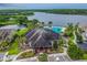 Stunning aerial view of the community clubhouse, pool, and lake, perfect for relaxation and recreation at 11504 Splendid Ln, Tampa, FL 33626