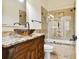 This bathroom features a custom vanity with a vessel sink, granite countertops, and a tiled shower at 11504 Splendid Ln, Tampa, FL 33626