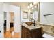 Charming bathroom with a unique glass bowl sink atop a marble vanity and decorative framed wall niches at 11504 Splendid Ln, Tampa, FL 33626