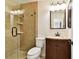 Modern bathroom featuring a tiled shower, dark vanity, and updated fixtures at 11504 Splendid Ln, Tampa, FL 33626