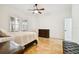 Well-lit bedroom featuring travertine floors, shuttered windows, and a wood dresser at 11504 Splendid Ln, Tampa, FL 33626