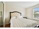 Comfortable bedroom with a plush bed, dark furniture, and a sunny window at 11504 Splendid Ln, Tampa, FL 33626