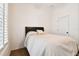 Cozy bedroom with neutral tones, a comfortable bed, and a window with plantation shutters at 11504 Splendid Ln, Tampa, FL 33626