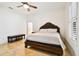 Bright bedroom with hardwood floors, a tufted headboard, and a view of the ensuite bathroom at 11504 Splendid Ln, Tampa, FL 33626