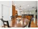 Open concept dining area showcasing a wood table, chairs, and a view into the adjacent kitchen at 11504 Splendid Ln, Tampa, FL 33626