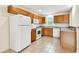 Bright kitchen with white appliances, oak cabinets, light countertops and tile flooring at 11504 Splendid Ln, Tampa, FL 33626
