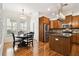 Bright kitchen and dining area with wood floors, wood cabinets, stainless steel appliances, and ample natural light at 11504 Splendid Ln, Tampa, FL 33626