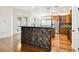 Open kitchen with breakfast bar, wood cabinets, stainless steel appliances, and hardwood floors at 11504 Splendid Ln, Tampa, FL 33626