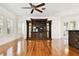 Spacious living room with wood floors, an entertainment center, and a ceiling fan at 11504 Splendid Ln, Tampa, FL 33626