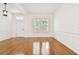 Bright living room featuring hardwood floors, crown molding, and plantation shutters at 11504 Splendid Ln, Tampa, FL 33626