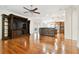 Open-concept living room with a large built-in entertainment center, wood floors, and great natural light at 11504 Splendid Ln, Tampa, FL 33626