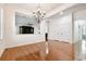 Open-concept living room with hardwood floors, decorative chandelier, and easy access to other living areas at 11504 Splendid Ln, Tampa, FL 33626