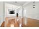 Open-concept living room featuring hardwood floors, white walls, and a clear view into the kitchen at 11504 Splendid Ln, Tampa, FL 33626