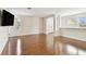 Spacious living room featuring gleaming floors, neutral walls, and a wall-mounted television at 11504 Splendid Ln, Tampa, FL 33626