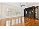 Bright living room with hardwood floors, plantation shutters, and a custom media center for entertainment at 11504 Splendid Ln, Tampa, FL 33626
