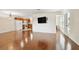 Open-concept living space boasts sleek flooring, neutral walls, and a modern, wall-mounted television at 11504 Splendid Ln, Tampa, FL 33626