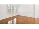 Bright living room with hardwood floors, large windows, and detailed wall trim, offering a spacious feel at 11504 Splendid Ln, Tampa, FL 33626