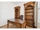 Home office featuring custom shelving, traditional wooden desk, and warm neutral carpeting at 11504 Splendid Ln, Tampa, FL 33626