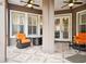 Inviting covered patio with neutral tile flooring, ceiling fans, and comfortable seating, perfect for outdoor relaxation and entertaining at 11504 Splendid Ln, Tampa, FL 33626