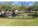Charming playground with slides, climbing structures, and benches, enclosed by a black metal fence in a lush, grassy area at 11504 Splendid Ln, Tampa, FL 33626