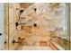 Close-up of a shower with designer tile work, a built-in bench, and a mounted shower head at 11504 Splendid Ln, Tampa, FL 33626