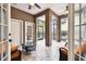 Cozy sunroom with tiled flooring, comfortable seating, and views of the outdoors at 11504 Splendid Ln, Tampa, FL 33626
