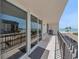 Balcony with seating overlooking ocean, condos, and beach at 1212 Benjamin Franklin Dr # 306, Sarasota, FL 34236