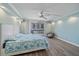 Bedroom with a ceiling fan and sliding glass doors to the balcony at 1212 Benjamin Franklin Dr # 306, Sarasota, FL 34236