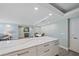 Kitchen island with granite counters adjacent to the dining and living area at 1212 Benjamin Franklin Dr # 306, Sarasota, FL 34236