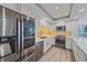 Modern kitchen featuring stainless steel appliances, white cabinetry, and a decorative backsplash at 1212 Benjamin Franklin Dr # 306, Sarasota, FL 34236