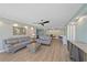 Bright living room featuring stylish sofas, a modern ceiling fan, and neutral walls at 1212 Benjamin Franklin Dr # 306, Sarasota, FL 34236