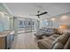 Bright living room featuring sliding glass doors to balcony, view of ocean, and modern furniture at 1212 Benjamin Franklin Dr # 306, Sarasota, FL 34236